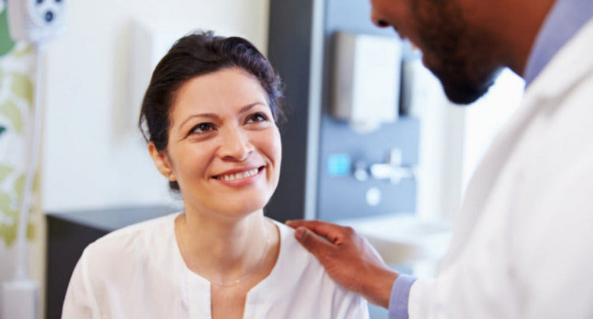 Woman receiving a check-up from a doctor in a medical setting